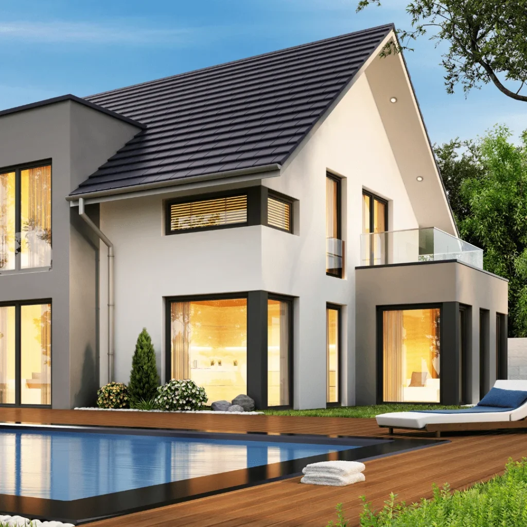 Modern two-story home with sleek exterior design, large windows, and poolside deck, showcasing high-end home remodeling services in Austin, TX.